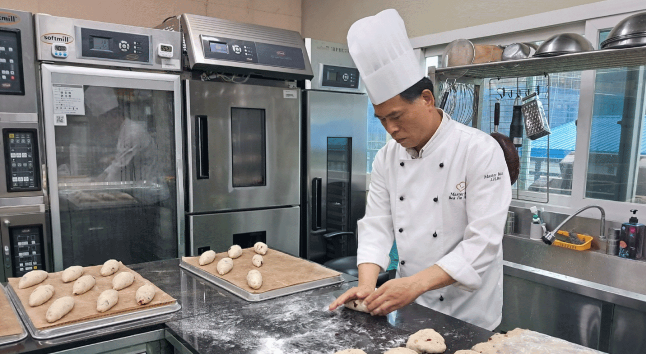 Photo image of an employee testing baking at a bakery